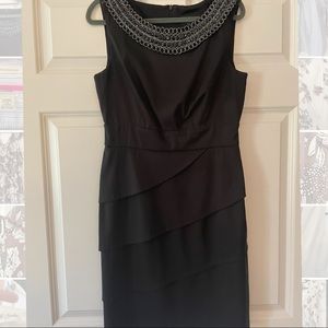 Formal black dress with layered skirt and embellished collar